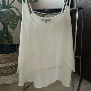 Cute white tank blouse. High low in front with skinny straps